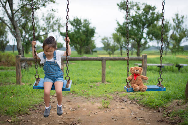 istock Little girl playing with teddy bear 942877798