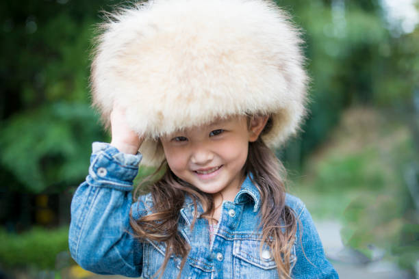 istock Little girl wearing a fur hat 942877808