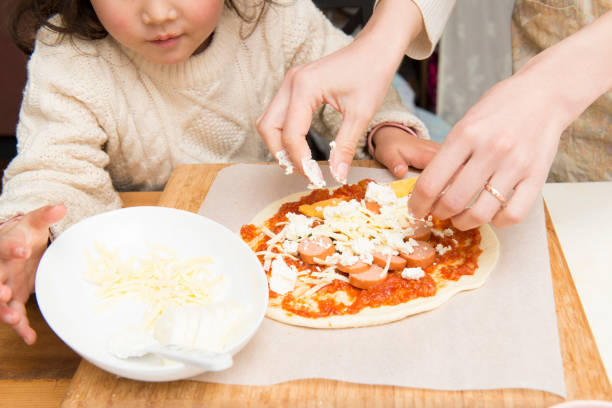Mother and daughter making pizza