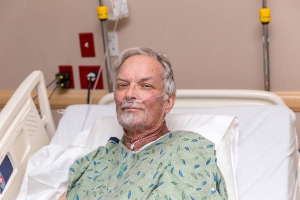 Elderly Man in Hospital Bed stock photo