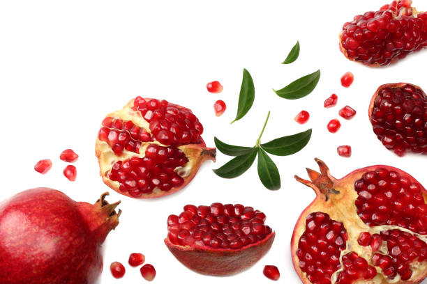 istock pomegranate fruit with green leaves isolated on a white background top view 942881278