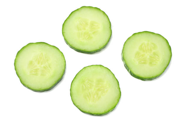istock fresh cucumber slices isolated on white background. top view 942881282