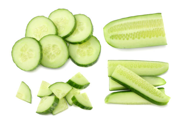istock fresh cucumber slices isolated on white background. top view 942881284