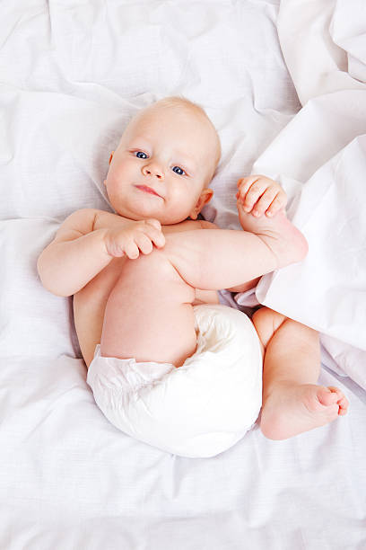 istock A baby holding its leg while in a diaper 94288433