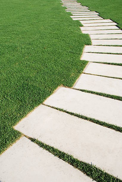 istock Serpentine pathway stones on a park lawn (concept) 94288483