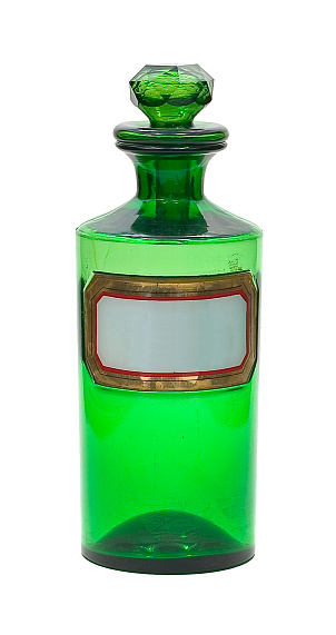Green glass bottle of sparkling water with metal cap on a white background