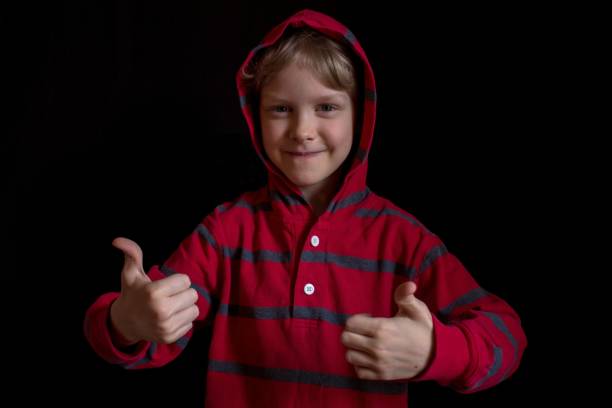istock boy showing a thumbs up 942889260