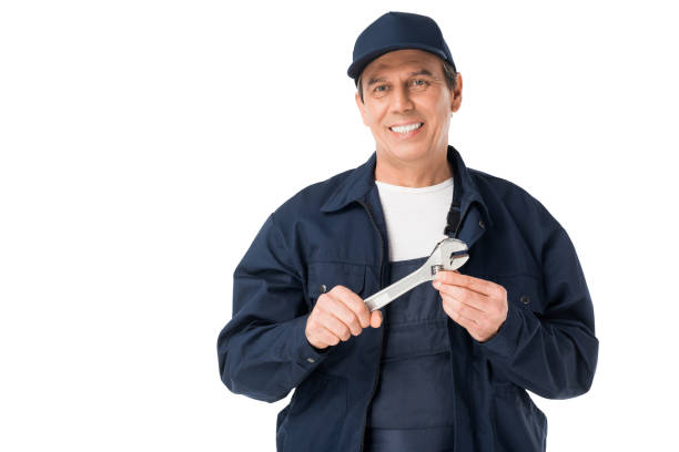istock Smiling repairman holding adjustable wrench isolated on white 942889730
