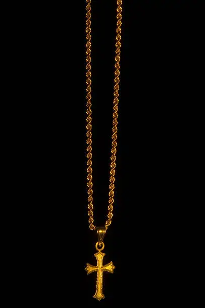 Photo of Cross on chain with black background
