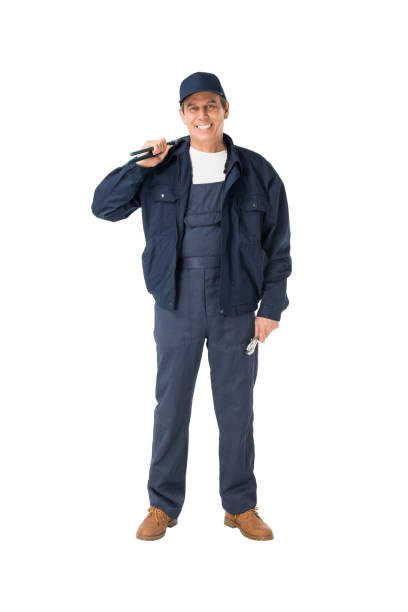 istock Handsome plumber in overalls holding adjustable wrenches isolated on white 942894792