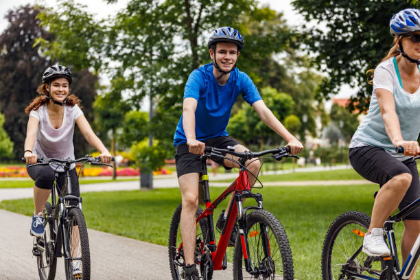 istock Urban biking- three people riding bikes in city 942895090