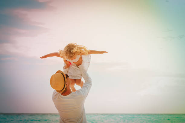 istock happy father and little daughter play at sky 942905486