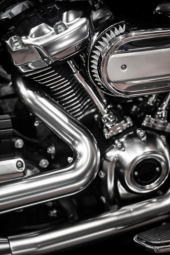 Dark metal motorcycle parts and tubes close-up view