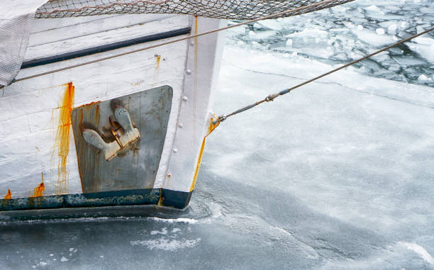 Ship hull in frozen harbor along Lake Superior in Duluth, Minnesota, USA in winter.