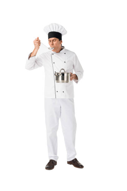 istock Smiling chef with pan tasting food isolated on white 942906132