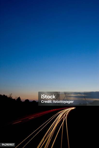 Car Lights Streaking Into Deep Blue Sky Stock Photo - Download Image Now - Lighting Equipment, Single Line, Autobahn