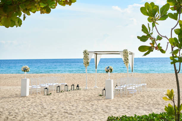 istock Beautiful beach wedding venue setting with flowers decoration, panoramic ocean view 942915798