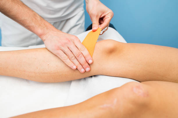 istock Kinesio taping knee application of a physiotherapist 942917318