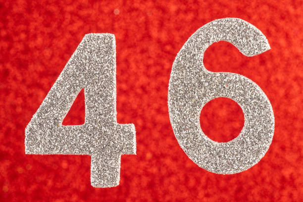 istock Number forty-six silver color over a red background. Anniversary. Horizontal 942919828