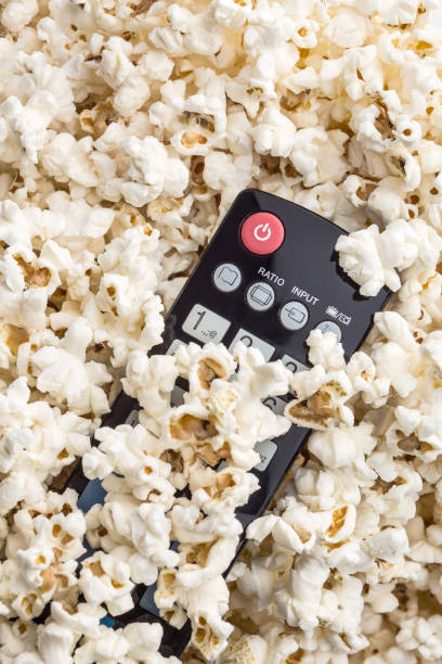 istock Tasty popcorn and tv remote control. 942920812