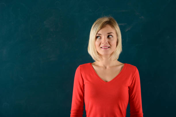 istock Young Woman Portrait on Blackboard 942924218