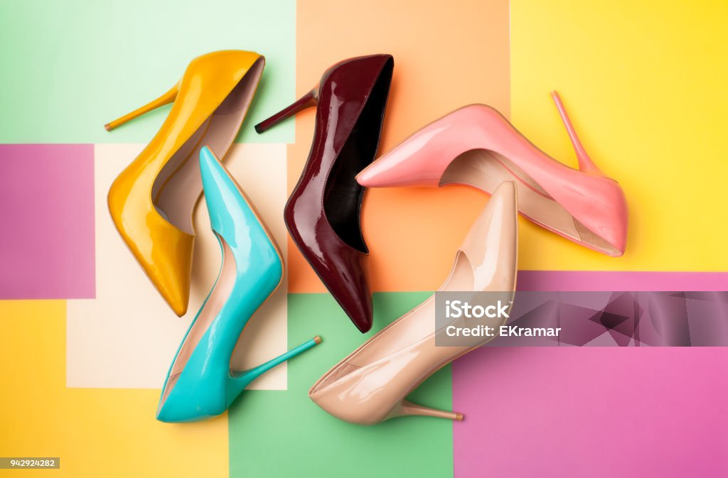 Set of colored women's shoes on a colored background Bright colored women's shoes on a solid background. Copy space text. Shoe Stock Photo
