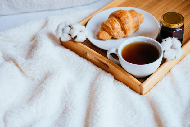 istock Coffee and croissant in bed 942926686