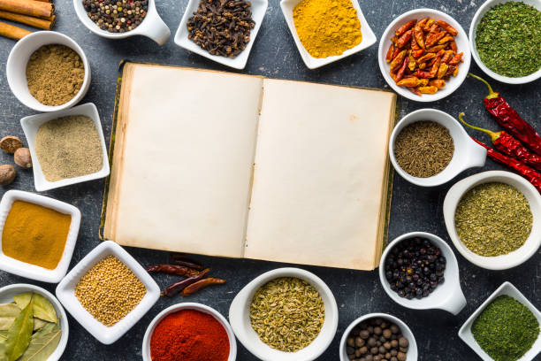 istock Blank cookbook and various spices and herbs. 942929688