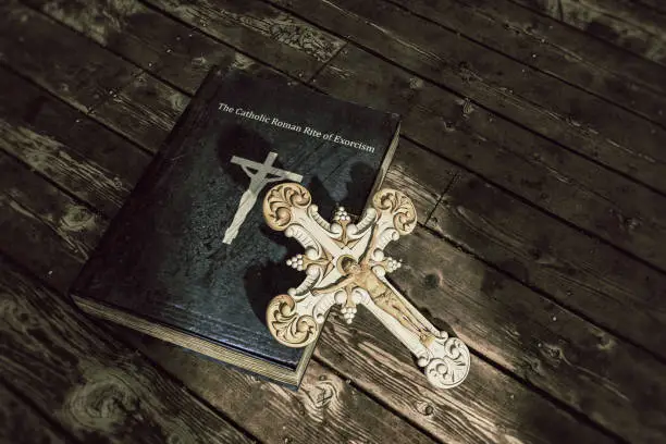3d illustration of exorcism book on wooden floor