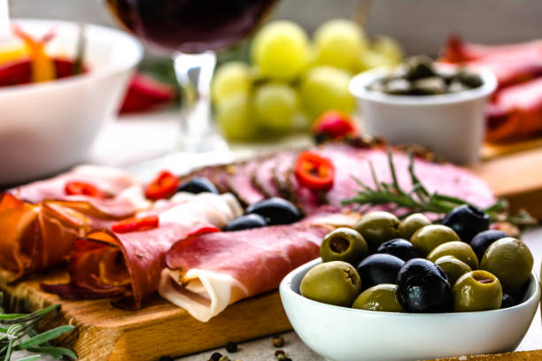 Antipasto platter. Cold meat, olives and other tapas on table, food selection from spain, mediterranean diet Antipasto platter. Cold meat, olives and other tapas on table, food selection from spain, mediterranean diet tapas photos stock pictures, royalty-free photos & images