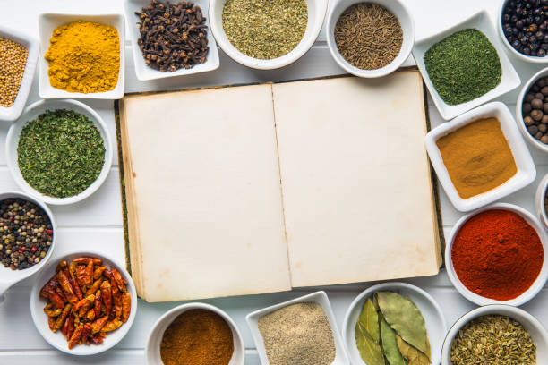 istock Blank cookbook and various spices and herbs. 942930240