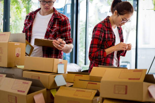 istock Online business owners are checking orders with documents, online business 942933108