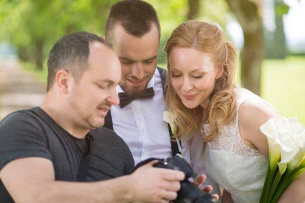 istock Wedding photographer showing the photos to the couple 942933708