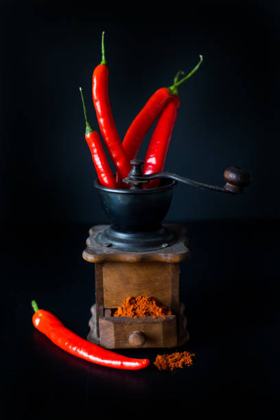 istock ground red pepper, grinder and paprikar on a black background 942933814