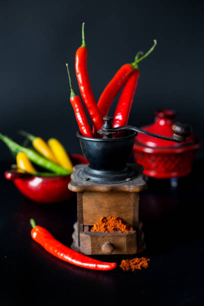 istock ground red pepper, grinder and paprikar on a black background 942933840