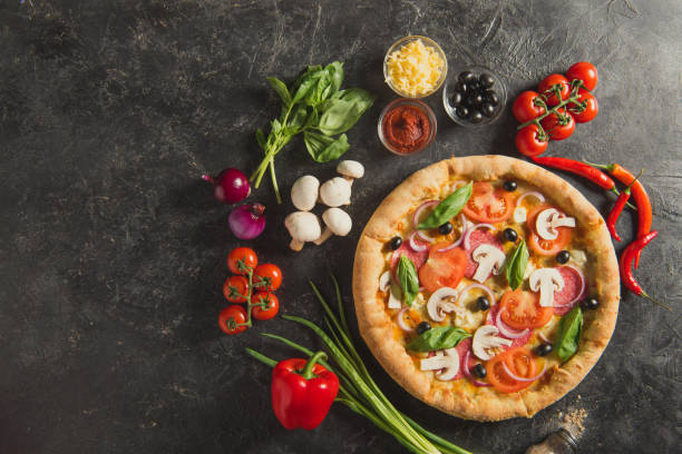 istock flat lay with italian pizza and fresh ingredients on dark surface 942934388