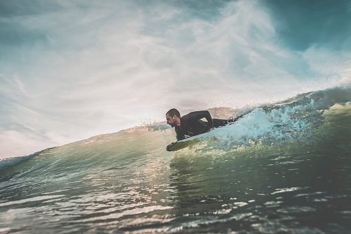 Man riding a wave on his bodyboard
