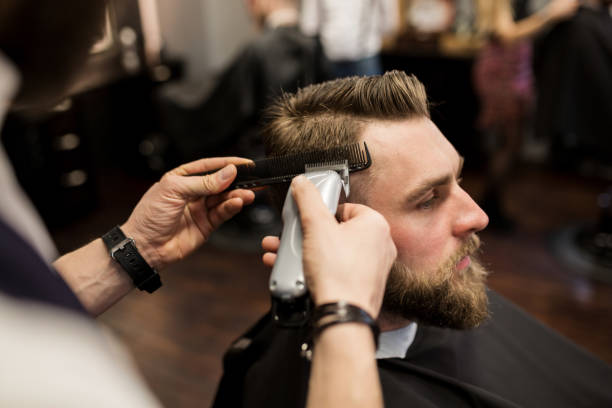 istock Young man having hair shaved at barber shop 942938544