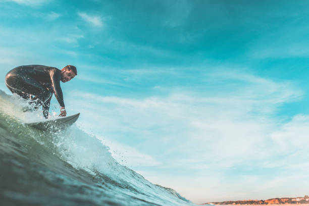 istock Young man surfing a wave on his surfboard 942938616