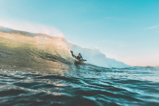 istock Surfer sliding down a wave with his bodyboard 942938622