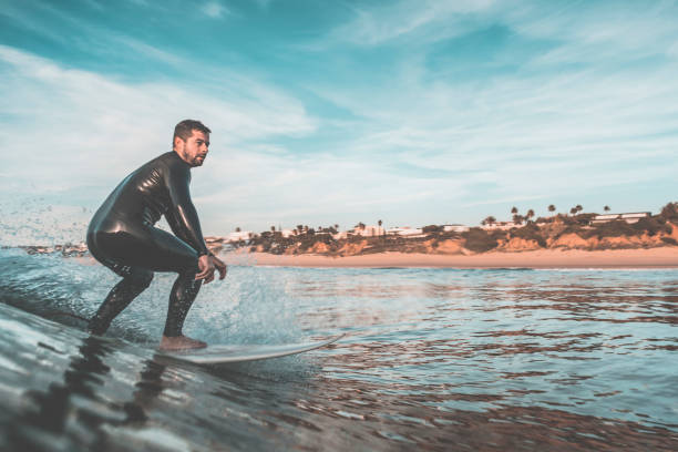 istock Man surfing a wave near to the coast 942938640