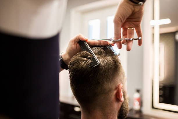 istock Customer having haircut at barber shop 942938680