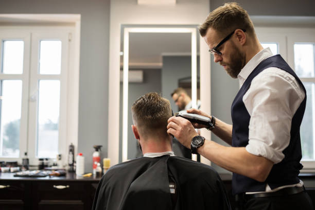istock Focused barber having customer hair 942941170