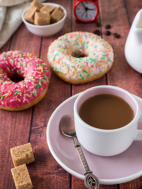 istock Donuts and coffee on wooden table. Top view with copy space 942941190