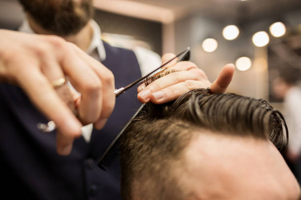 istock Barber cutting customer hair 942941216