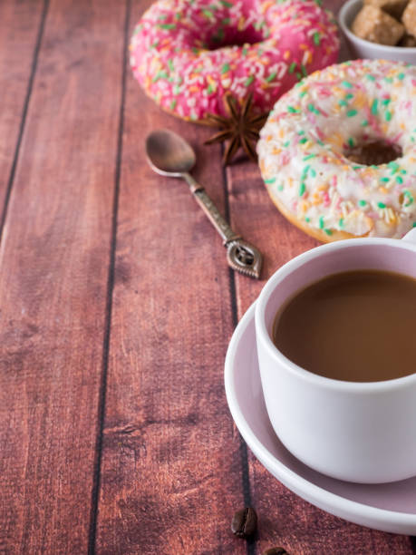 istock Donuts and coffee on wooden table. Top view with copy space 942941336