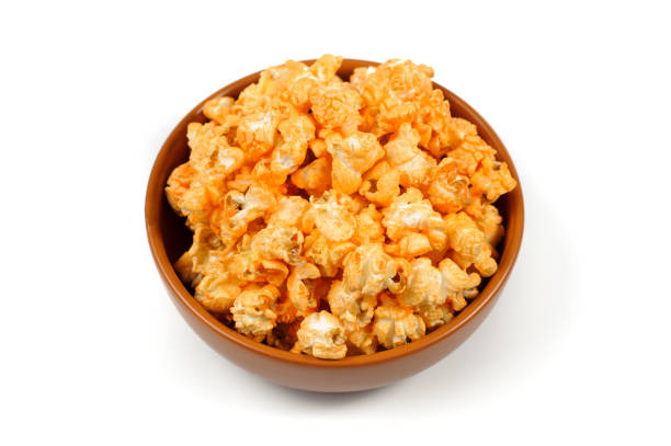 istock delicious , spicy popcorn in a clay brown plate on a white background 942941632