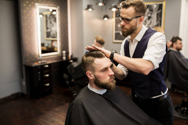 istock Focused barber working on customer hair 942948752