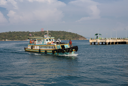 Koh Sichang, Thailand - January 30, 2018: The passenger boat coming from the mainland is entering Koh Sichang or Sichang island port.