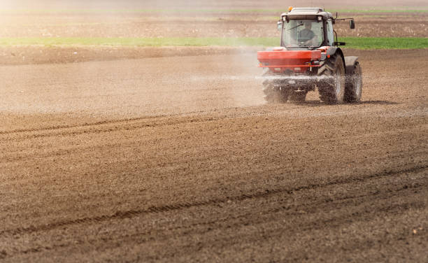 istock Tractor spraying pesticides on wheat field with sprayer at spring 942949492